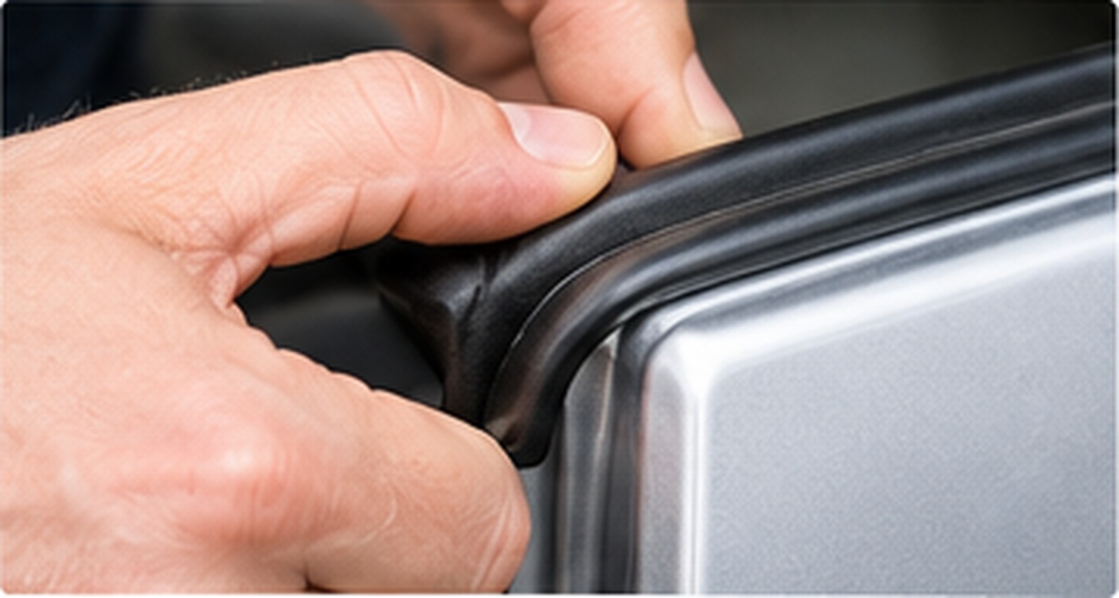 Fitting a self-gripping rubber door seal onto a vehicle panel edge